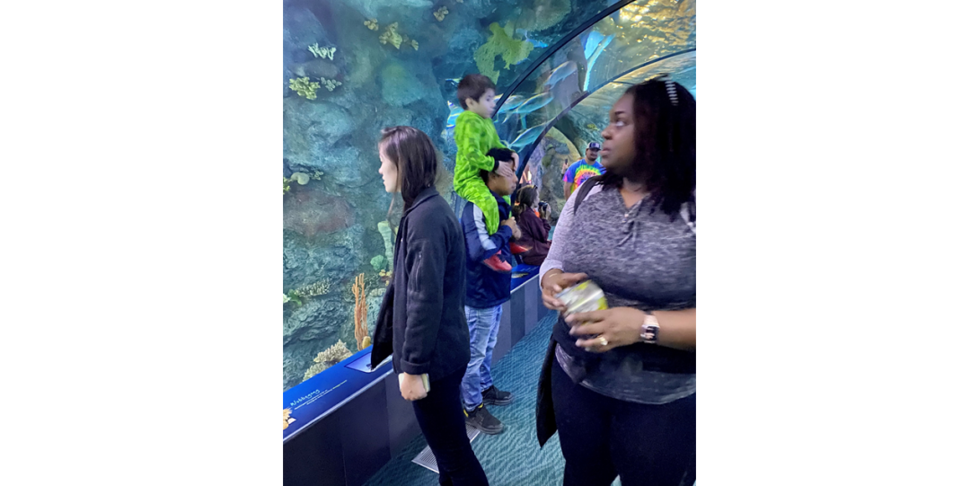 Two women next to aquarium at the Zoo