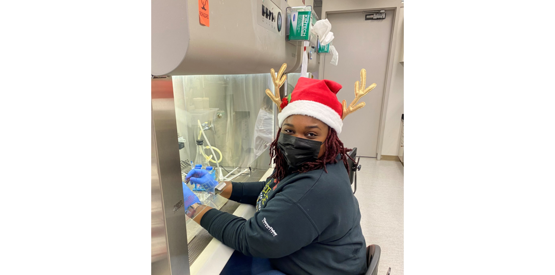 Diandra Taylor in Santa's Hat and Reindeer antlers passaging cells in biohood at the biohood