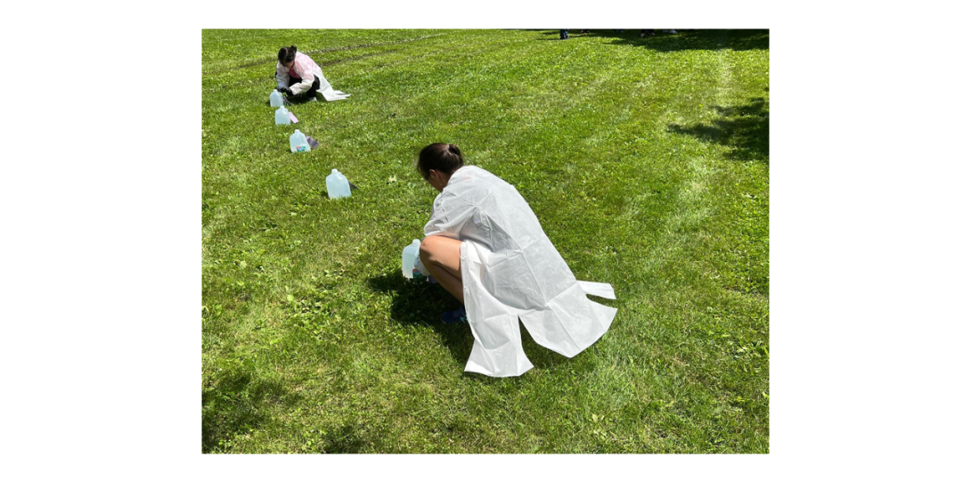 Woman on the grass in white lab coats